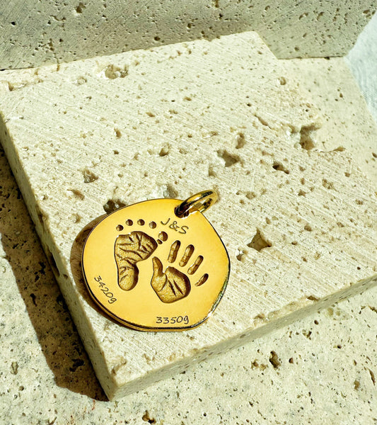 18k Gold Vermeil personalize baby hand and foot print pendant on a texture background